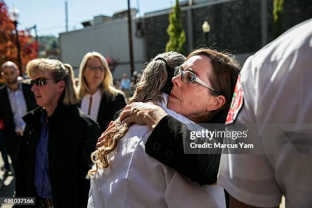 Governor Kate Brown hugs Douglas County Fire District Battalion Chief Teresa Mutschler after a press conference outside the Roseburg Fire Department...