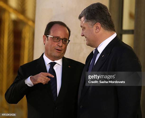 French President Francois Hollande talks to Ukrainian President Petro Poroshenko after the Normandy Format Summit in the Elysee Palace on October 2,...