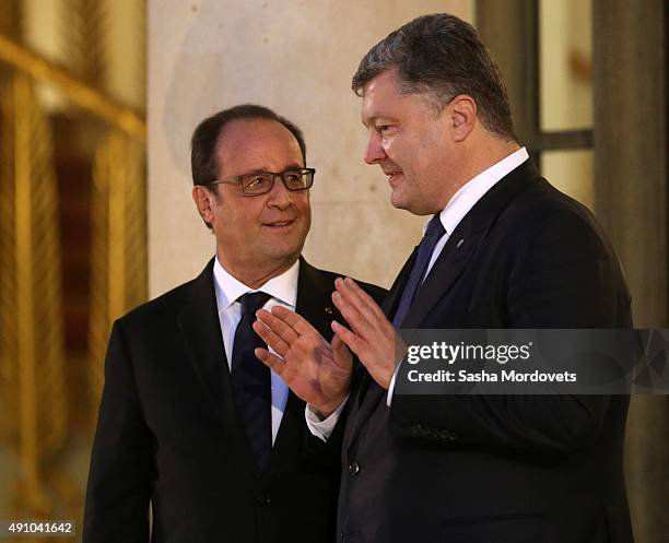 French President Francois Hollande listens to Ukrainian President Petro Poroshenko after the Normandy Format Summit in the Elysee Palace on October...