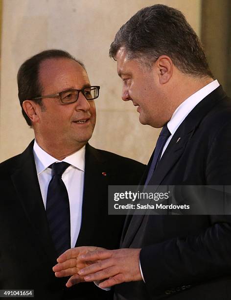 French President Francois Hollande listens to Ukrainian President Petro Poroshenko after the Normandy Format Summit in the Elysee Palace on October...