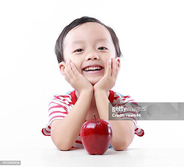 child holding apple - red apples stock pictures, royalty-free photos & images