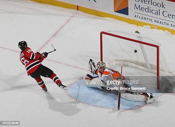 Jacob Josefson of the New Jersey Devils scores the shootout winner over Steve Mason of the Philadelphia Flyers at the Prudential Center on October 2,...