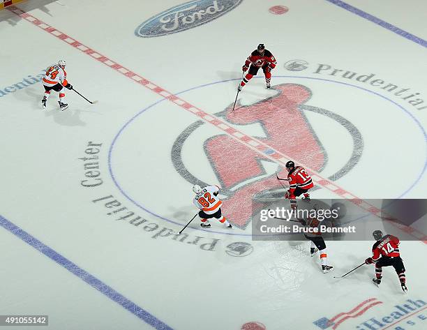 The New Jersey Devils and the Philadelphia Flyers play 3 on 3 in overtime at the Prudential Center on October 2, 2015 in Newark, New Jersey. The...