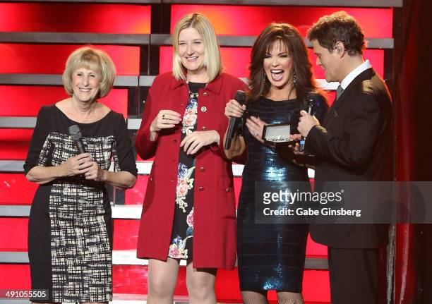 Clark County Commissioner Susan Brager and Regional President of the Flamingo Las Vegas Eileen Moore look on as entertainers Marie Osmond and her...