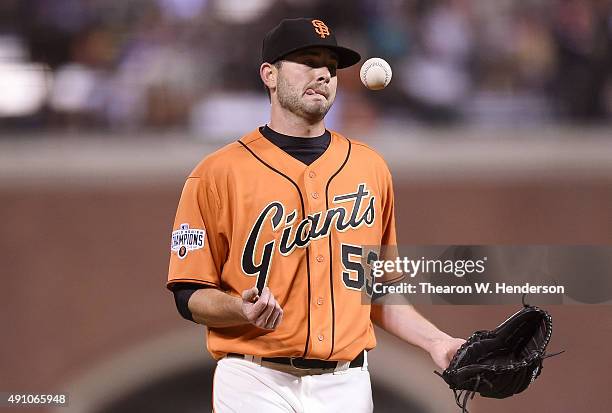 Chris Heston of the San Francisco Giants reacts after giving up a two-run RBI double to Jose Reyes of the Colorado Rockies in the top of the fourth...