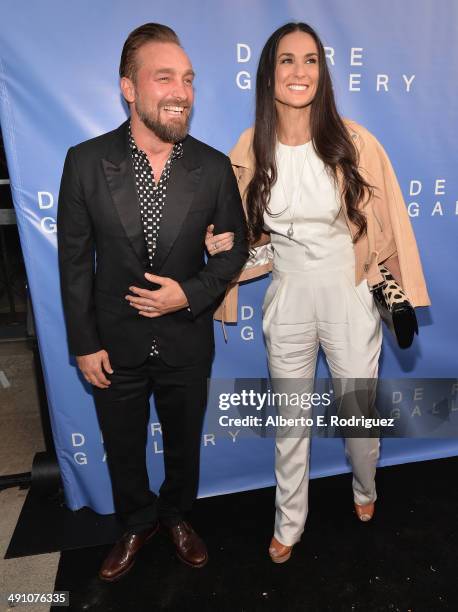 Photographer Brian Bowen Smith and actress Demi Moore attend the opening of The De Re Gallery on May 15, 2014 in Los Angeles, California.