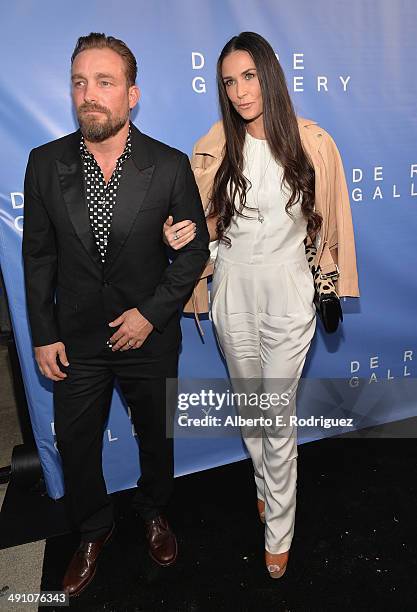 Photographer Brian Bowen Smith and actress Demi Moore attend the opening of The De Re Gallery on May 15, 2014 in Los Angeles, California.