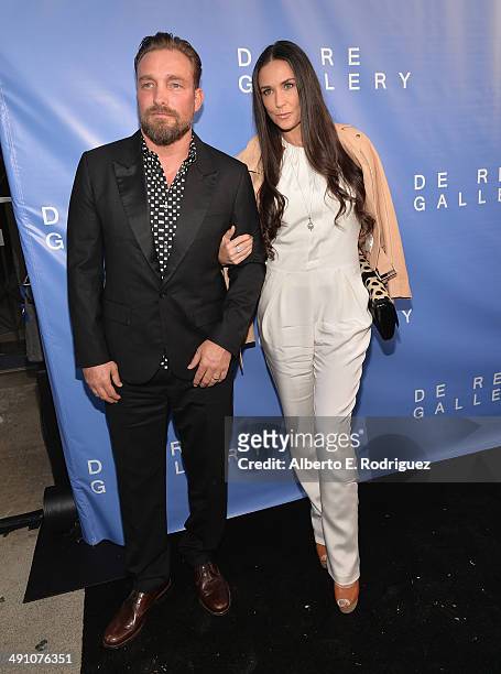 Photographer Brian Bowen Smith and actress Demi Moore attend the opening of The De Re Gallery on May 15, 2014 in Los Angeles, California.
