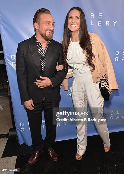 Photographer Brian Bowen Smith and actress Demi Moore attend the opening of The De Re Gallery on May 15, 2014 in Los Angeles, California.
