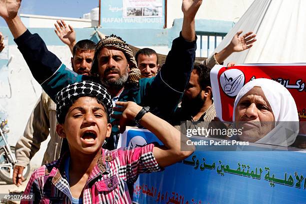 Palestinians protest in front of the UNRWA headquarters against their decision to reduce aid in the Rafah refugee camp in the southern Gaza Strip....