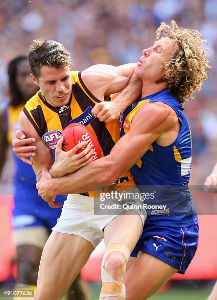 Isaac Smith of the Hawks is tackled by Matt Priddis of the Eagles during the 2015 AFL Grand Final match between the Hawthorn Hawks and the West Coast...