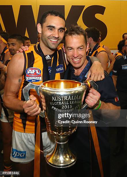 Shaun Burgoyne and Alastair Clarkson the coach of the Hawks celebrates with the trophy after winning the 2015 AFL Grand Final match between the...