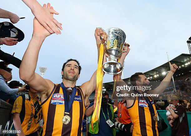 Jordan Lewis and Luke Hodge of the Hawks celebrates with the trophy after winning the 2015 AFL Grand Final match between the Hawthorn Hawks and the...