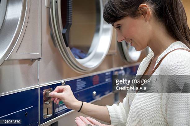 woman in laundromat - washing mashine stock pictures, royalty-free photos & images