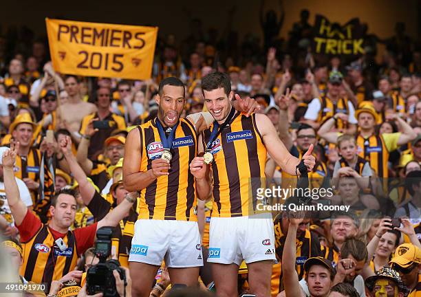 Josh Gibson and Ben Stratton of the Hawks celebrate with the crowd after winning the 2015 AFL Grand Final match between the Hawthorn Hawks and the...