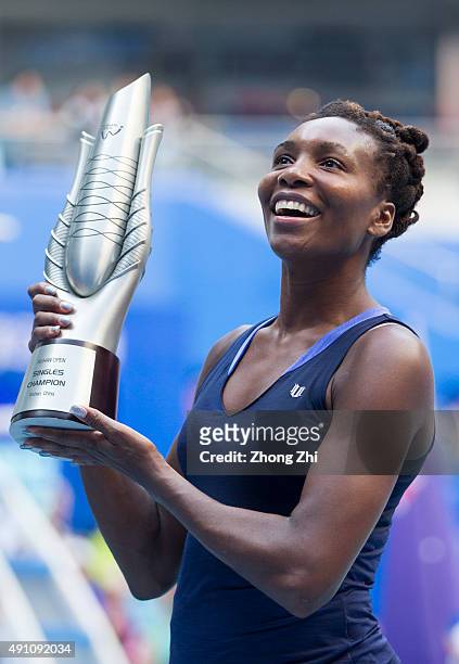Venus Williams of USA poses with her trophy after winning the women's singles final against Garbine Muguruza of Spain during Day 7 of 2015 Dongfeng...