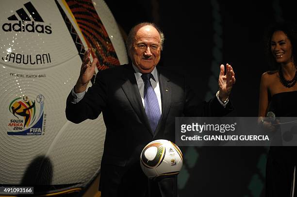 President Sepp Blatter poses with 'Jabulani' the official match ball for the 2010 World Cup during the handover event on December 4, 2009 in Cape...