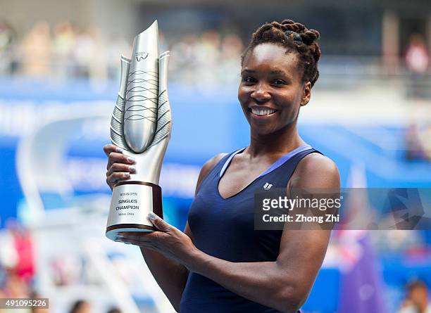 Venus Williams of USA poses with her trophy after winning the women's singles final against Garbine Muguruza of Spain during day 7 of 2015 Dongfeng...