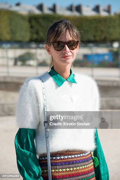 Fashion Stylist and Model Clara Racz wears a vintage top, sweater and skirt, MCM bag and Maui sunglasses on day 4 during Paris Fashion Week...