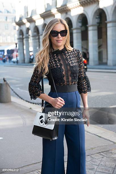 Fashion Blogger Maja Malnar wears a Self Portrait jumpsuit, Karen Walker sunglasses and a Les Petit Joueurs bag on day 4 during Paris Fashion Week...