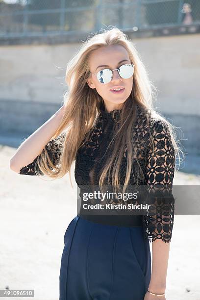 Fashion Blogger Sandra Hagelstam wears a Self Portrait jumpsuit, Rayban sunglasses, and Lapponia jewellery on day 4 during Paris Fashion Week...