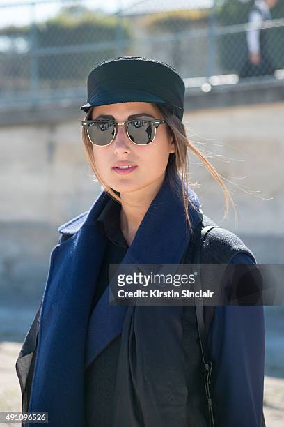 Fashion Blogger Julia Haghjoo wears a Gauchere vest, top and hat, Hugo Boss bag, Rayban sunglasses and My Cosy Couture scarf on day 4 during Paris...