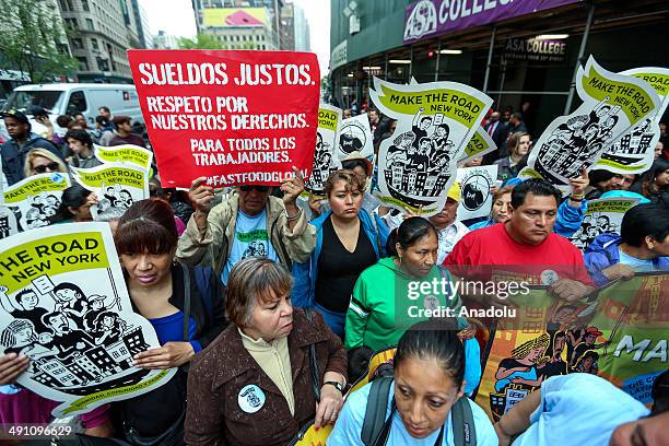 Protesters demanding higher wages for fast food workers chant during a massive rally in Manhattan Herald Square of New York City on May 15, 2014. The...