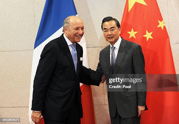 French Foreign Minister Laurent Fabius speaks to Chinese Foreign Minister Wang Yi at China's National Museum on May 16, 2014 in Beijing, China....