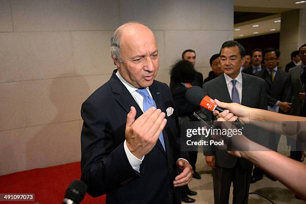 French Foreign Minister Laurent Fabius speaks to the media as Chinese Foreign Minister Wang Yi looks on at China's National Museum on May 16, 2014 in...