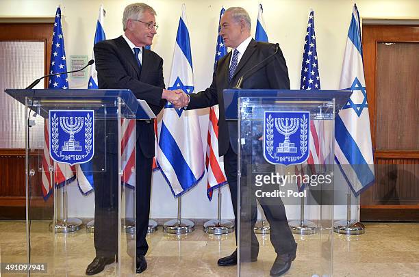 Israeli Prime Minister Benjamin Netanyahu shakes hands with US Defense Secretary Chuck Hagel during a press conference at the prime minister's office...