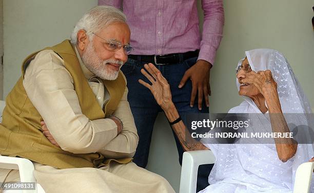 Chief Minister of western Gujarat state and main opposition Bharatiya Janata Party prime ministerial candidate Narendra Modi listens to his mother...