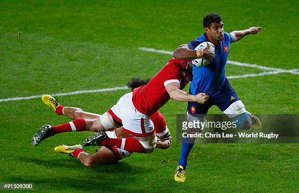 Wesley Fofana of France is tackled by Jamie Cudmore and Kyle Gilmour of Canada during the 2015 Rugby World Cup Pool D match between France and Canada...