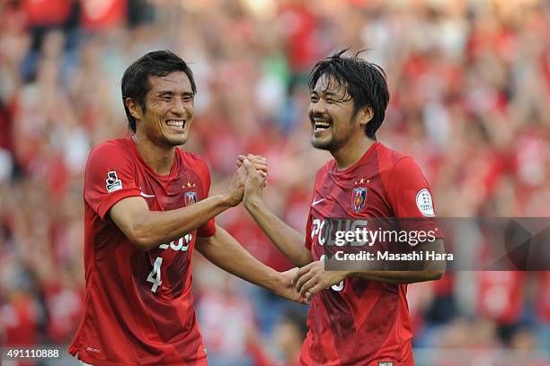 Shinzo Koroki of Urawa Red Diamonds celebrates the first goal with a team mate during the J.League match between Urawa Red Diamonds and Sagan Tosu at...