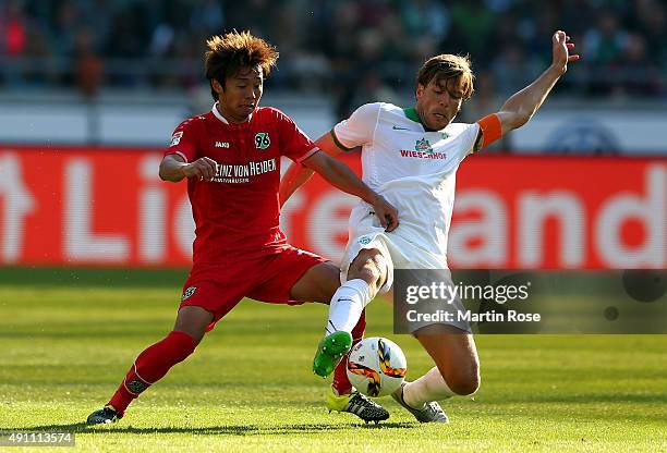 Hiroshi Kiyotake of Hannover battles for the ball with Clemens Fritz of Bremen during the Bundesliga match between Hannover 96 and Werder Bremen at...