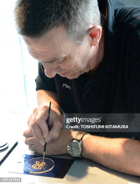 Rolls Royce motor cars painting craftman Mark Court performs during Rolls Royce motor cars painting craftman Mark Court performs during