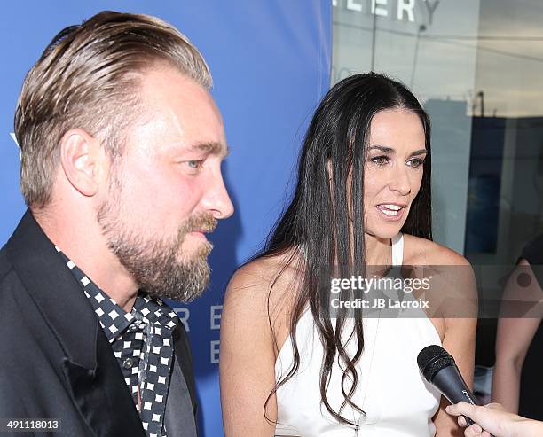 Brian Bowen Smith and Demi Moore attend the grand opening of the De Re Gallery on May 15, 2014 in West Hollywood, California.