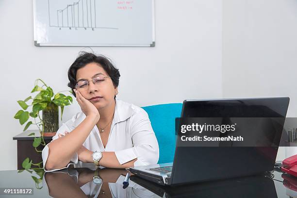 overworked and stressed out businesswoman, takes a break. - women india partition stock pictures, royalty-free photos & images