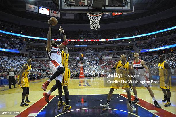 Washington forward Nene Hilario drives for the basket past Indiana center Roy Hibbert in the first half as the Washington Wizards play the Indiana...