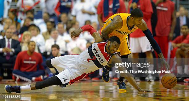 Washington guard John Wall , left, turns the ball over to Indiana forward Paul George in the final minutes of the game as the Indiana Pacers defeat...