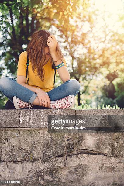unhappy teenage girl outside - mental illness child stock pictures, royalty-free photos & images