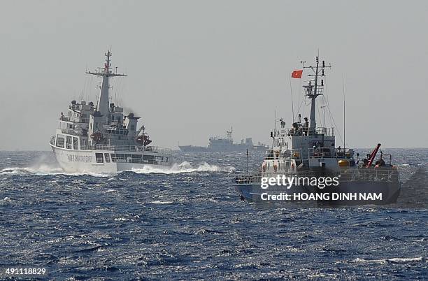 This picture taken on May 14, 2014 shows a Chinese coast guard vessel followed by a Vietnamese coast guard ship near the area of China's oil drilling...