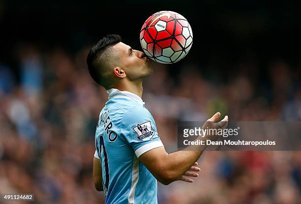 Sergio Aguero of Manchester City kisses the ball to celebrate a goal during the Barclays Premier League match between Manchester City and Newcastle...