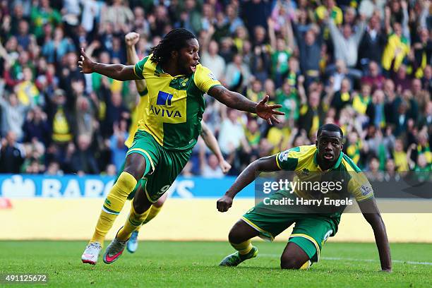 Dieumerci Mbokani of Norwich City celebrates scoring his team's first goal during the Barclays Premier League match between Norwich City and...