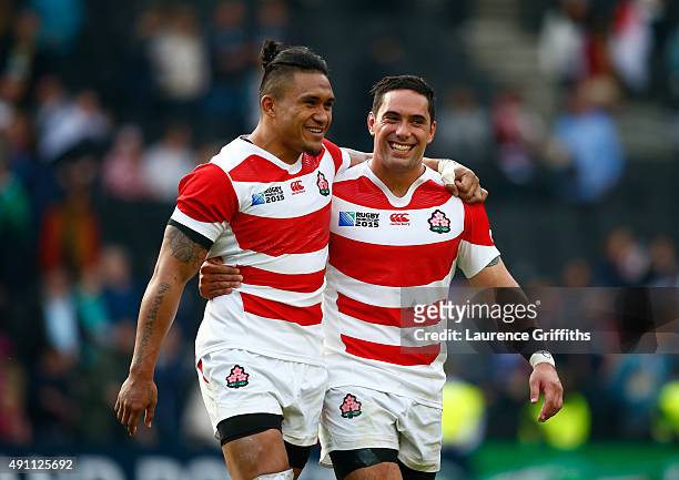 Male Sau and Karne Hesketh of Japan celebrate after the the 2015 Rugby World Cup Pool B match between Samoa and Japan at Stadium mk on October 3,...