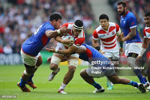 Hendrik Tui of Japan is tackled by Ofisa Treviranus of Samoa during the 2015 Rugby World Cup Pool B match between Samoa and Japan at Stadium mk on...