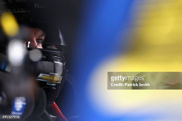 Dale Earnrhardt Jr., driver of the Nationwide Plenti Chevrolet, sits in his car during practice for the NASCAR Sprint Cup Series AAA 400 at Dover...