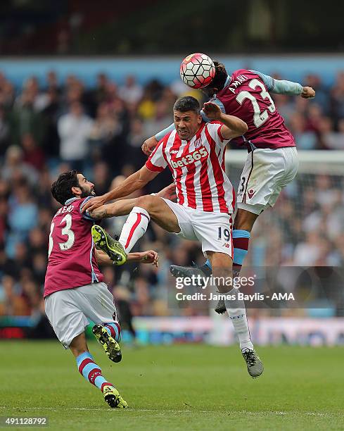 Jonathan Walters of Stoke City is challenged by Jordan Amavi and Jose Angel Crespo of Aston Villa during the Barclays Premier League match between...