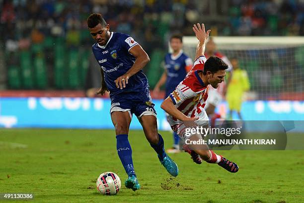 Atletico-de-Kolkata's Helder Manuel Marques Postiga falls while Chennaiyin forward Jayesh Rane takes the ball during the Indian Super League football...