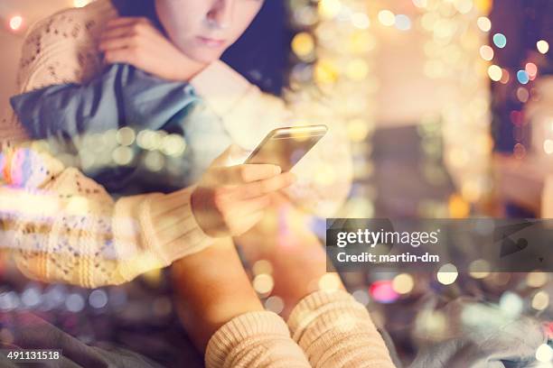 fille dans le lit à l'aide de téléphone - cyber harcèlement photos et images de collection