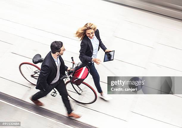 business couple on the street - walking business man outside stock pictures, royalty-free photos & images